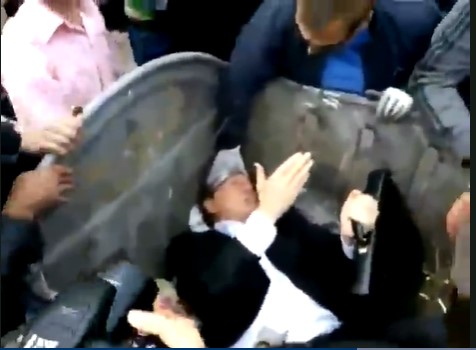 Ukrainian Protestors Throw Politician Into Dumpster
