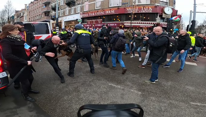 Police use DOGS and BATONS to disperse anti-lockdown protesters in Amsterdam